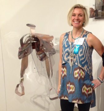 Maeve Eichelberger posing next to her saddle sculpture