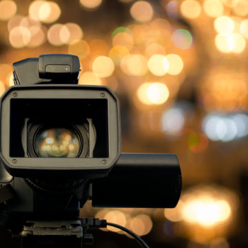 video camera with blurred lights in background