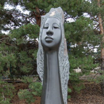 Spring stone sculpture of female bust with elongated neck by Agnes Nyanhongo
