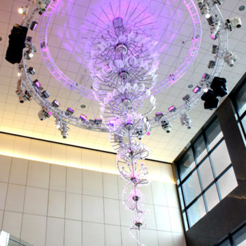 Crystal, glass, and stainless steel, spiraling chandelier by Lonnie Hanzon