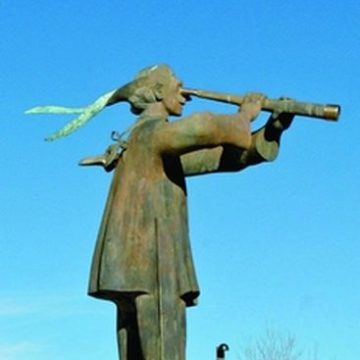Bronze performer on stilts with telescope by Harry Marinsky